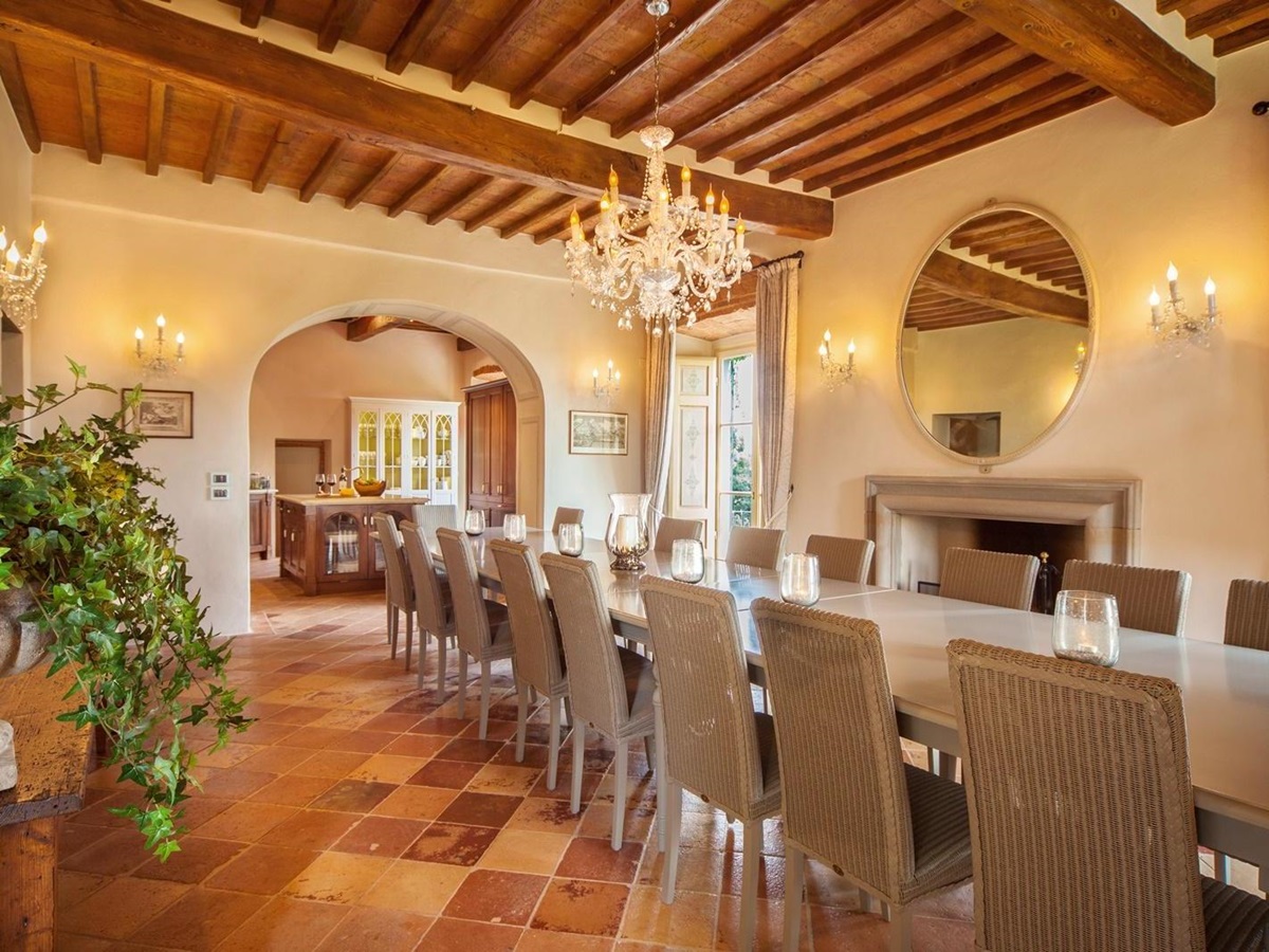 Well lit open dining room with chandelier in Villa Nocciola, Tuscany