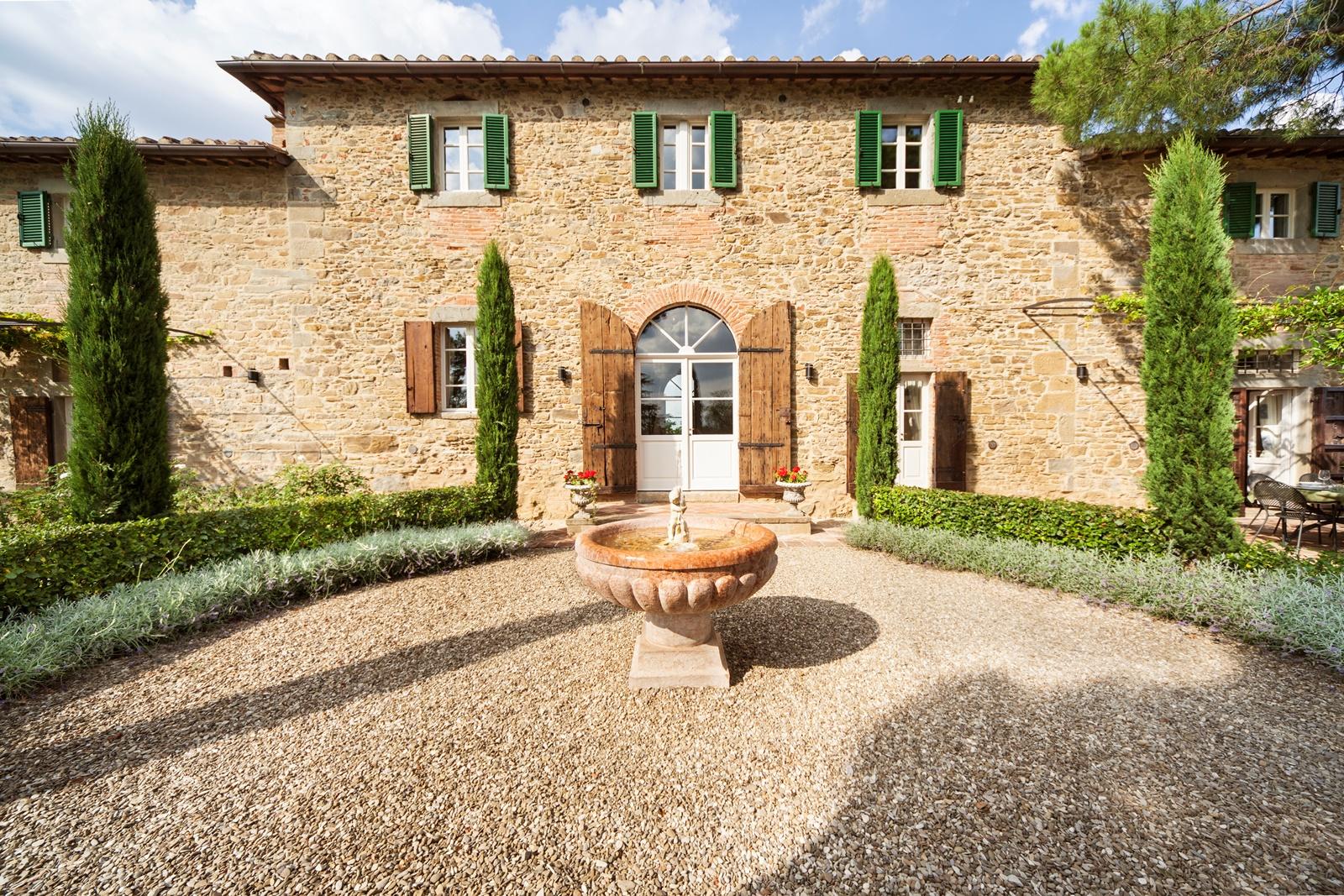 The exterior of Villa Nocciola with a little fountain, Tuscany
