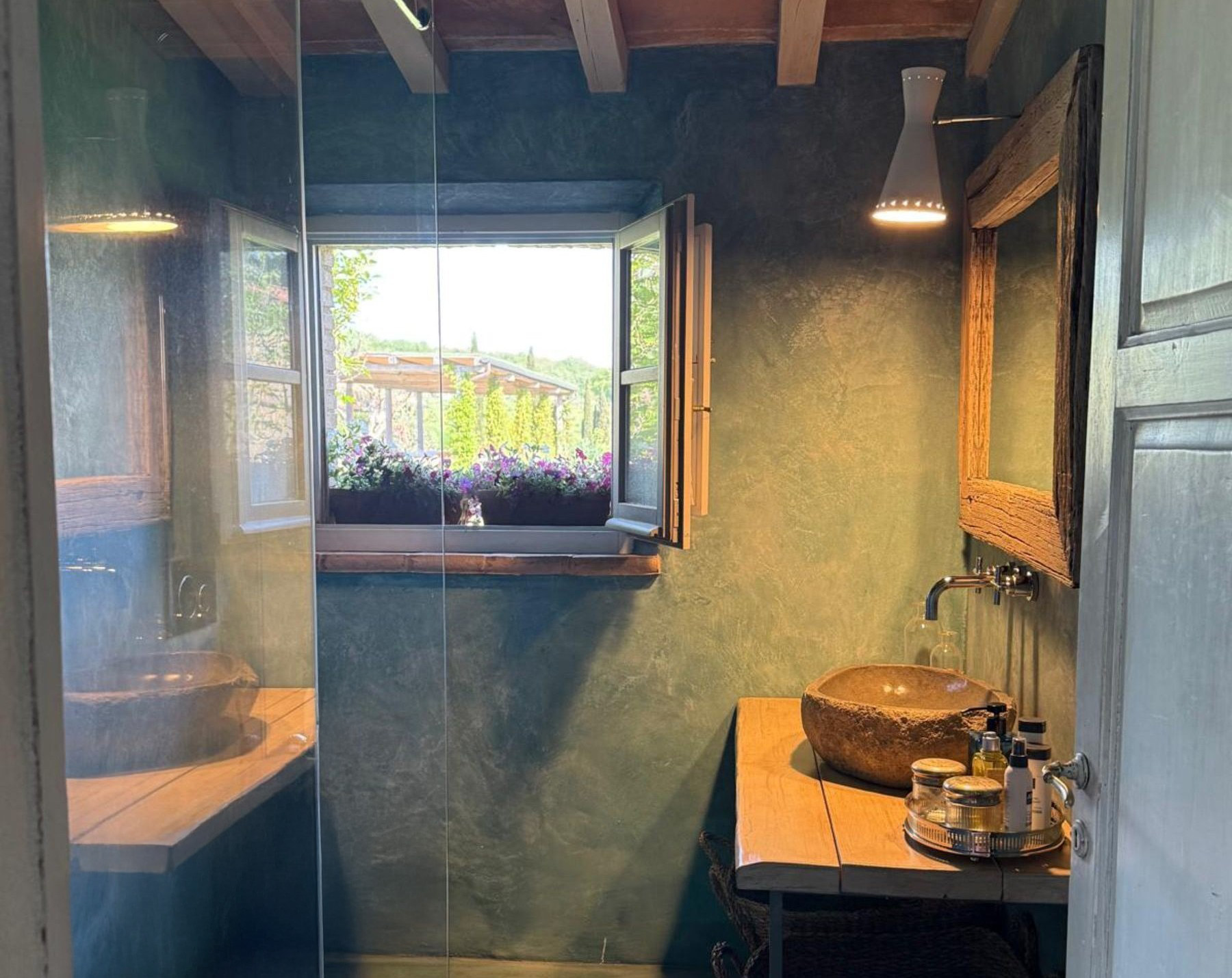 Bathroom sink and window view at Villa Pacetezza in Tuscany