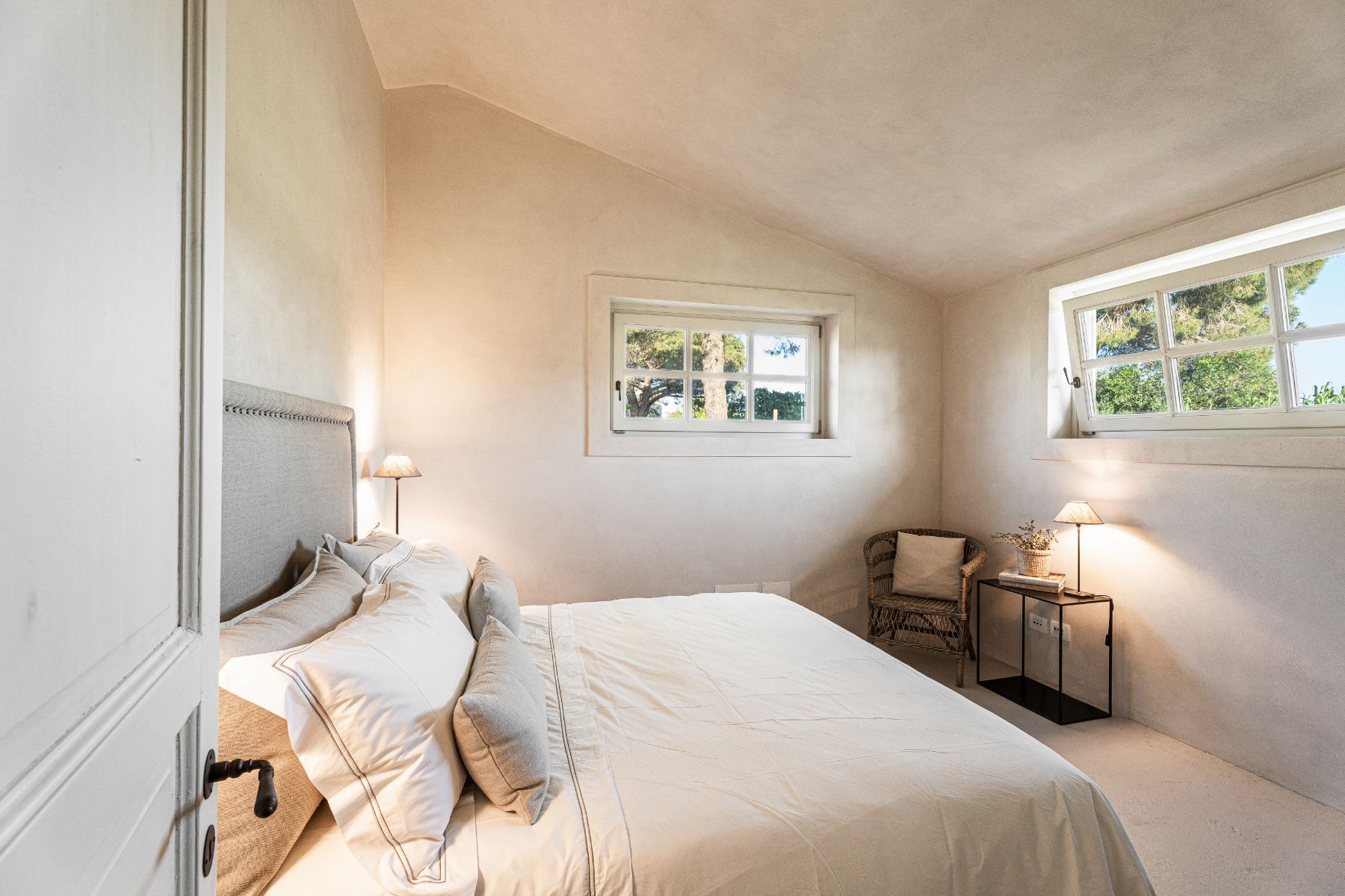 Bedroom with two windows in Villa Pedemontana in Tuscany