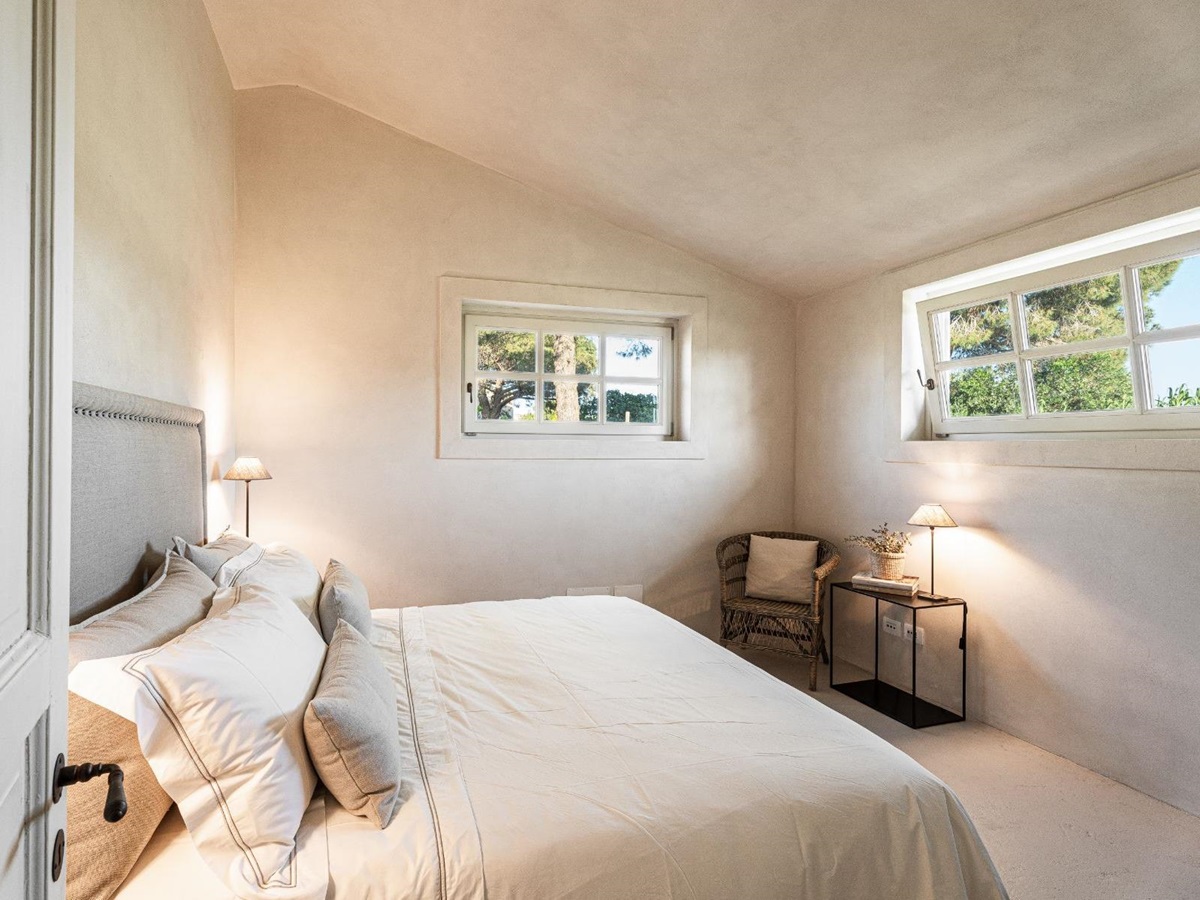 Bedroom with two windows in Villa Pedemontana in Tuscany