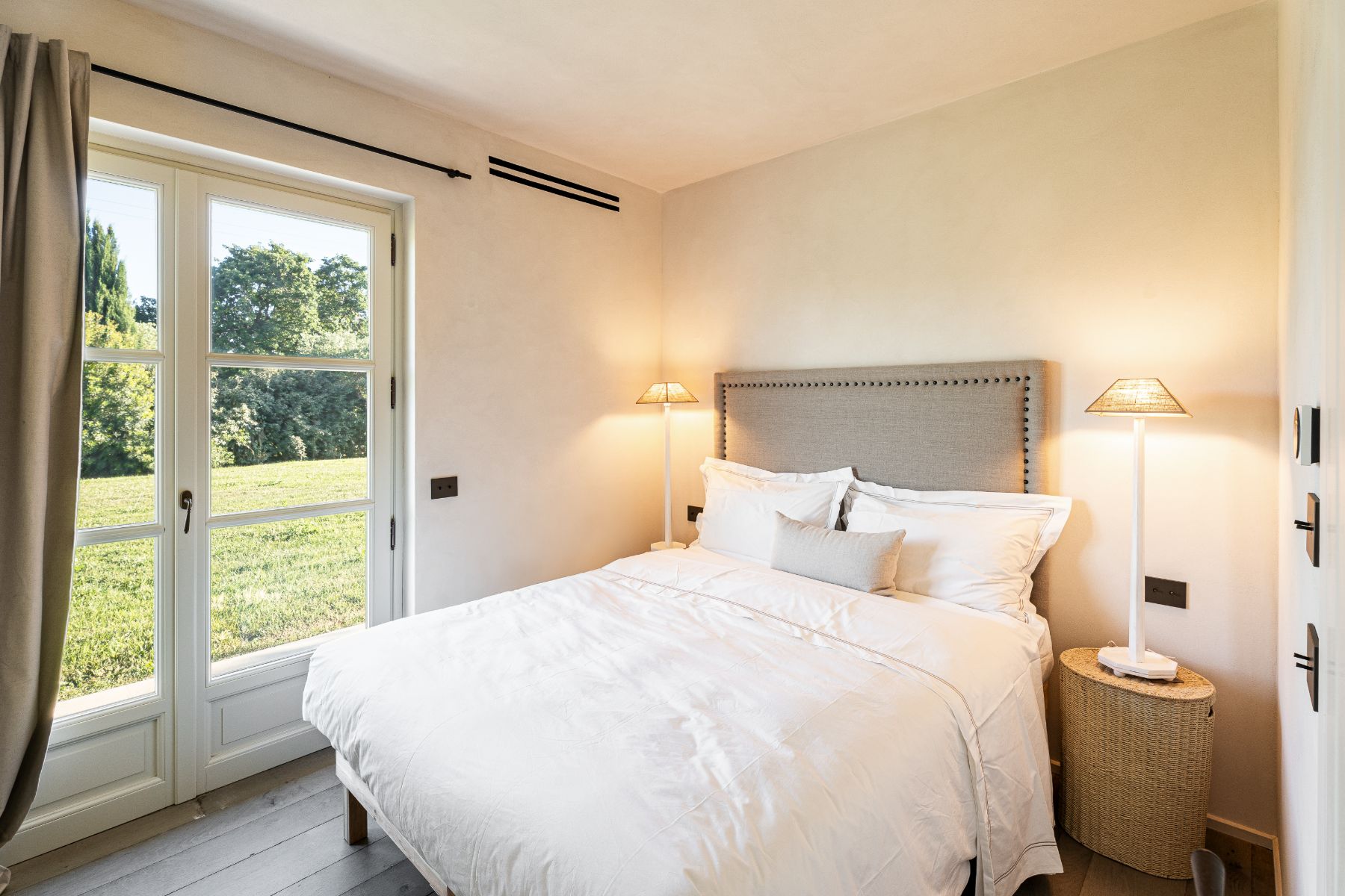 Bedroom with door to garden in Villa Pedemontana in Tuscany