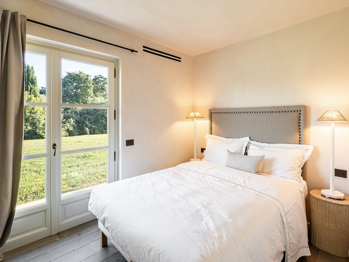 Bedroom with door to garden in Villa Pedemontana in Tuscany