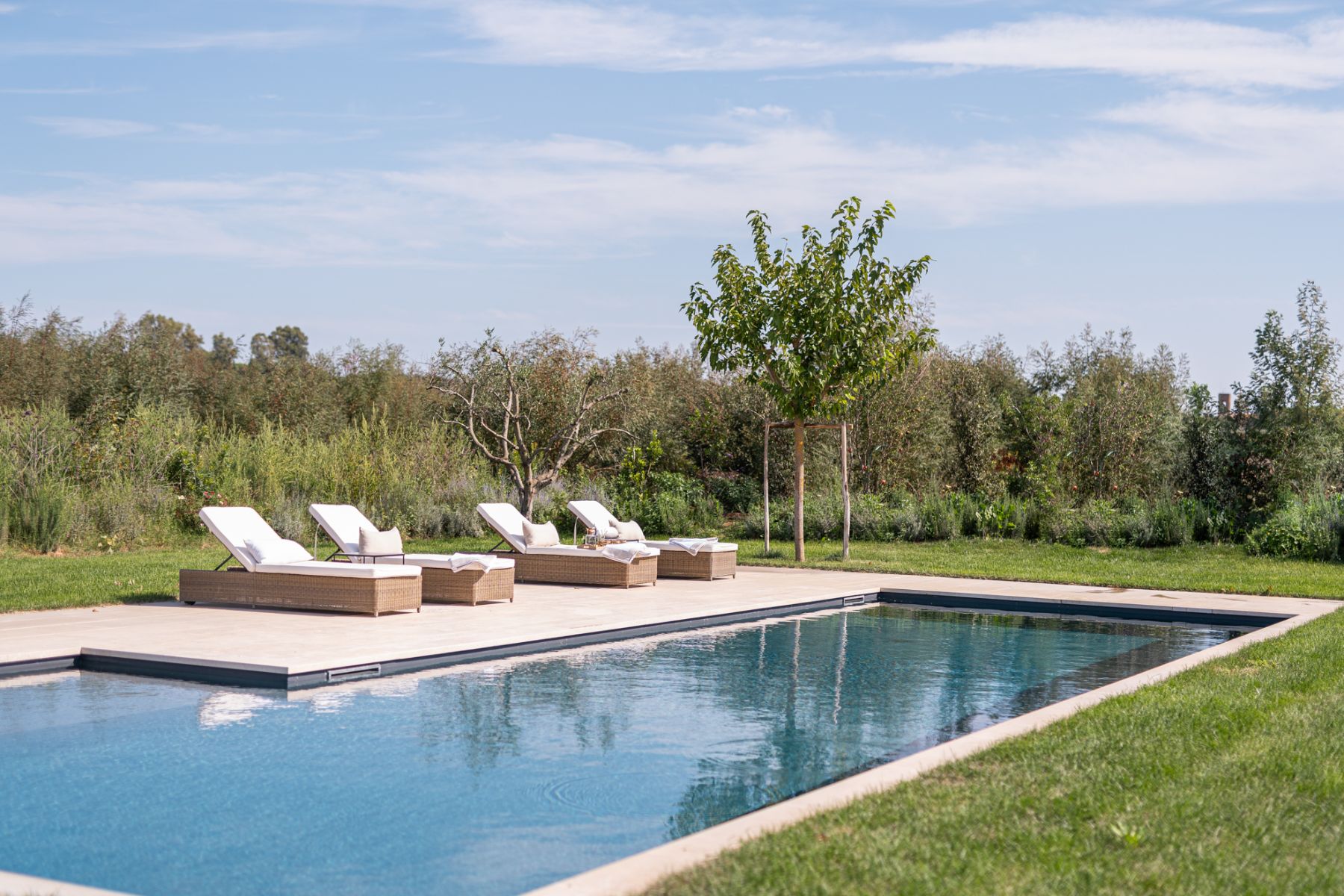 Close up of pool with deck chairs in Villa Pedemontana in Tuscany