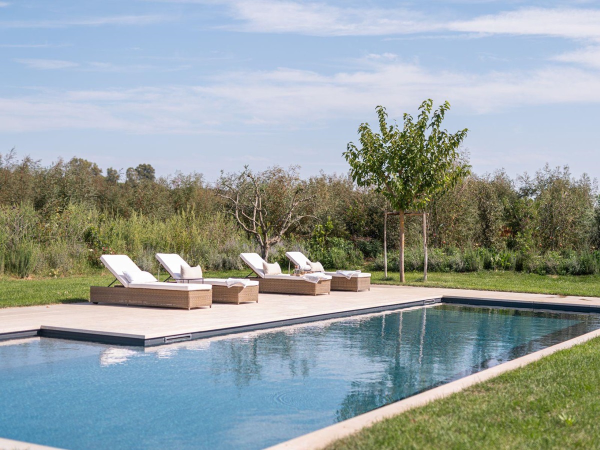 Close up of pool with deck chairs in Villa Pedemontana in Tuscany