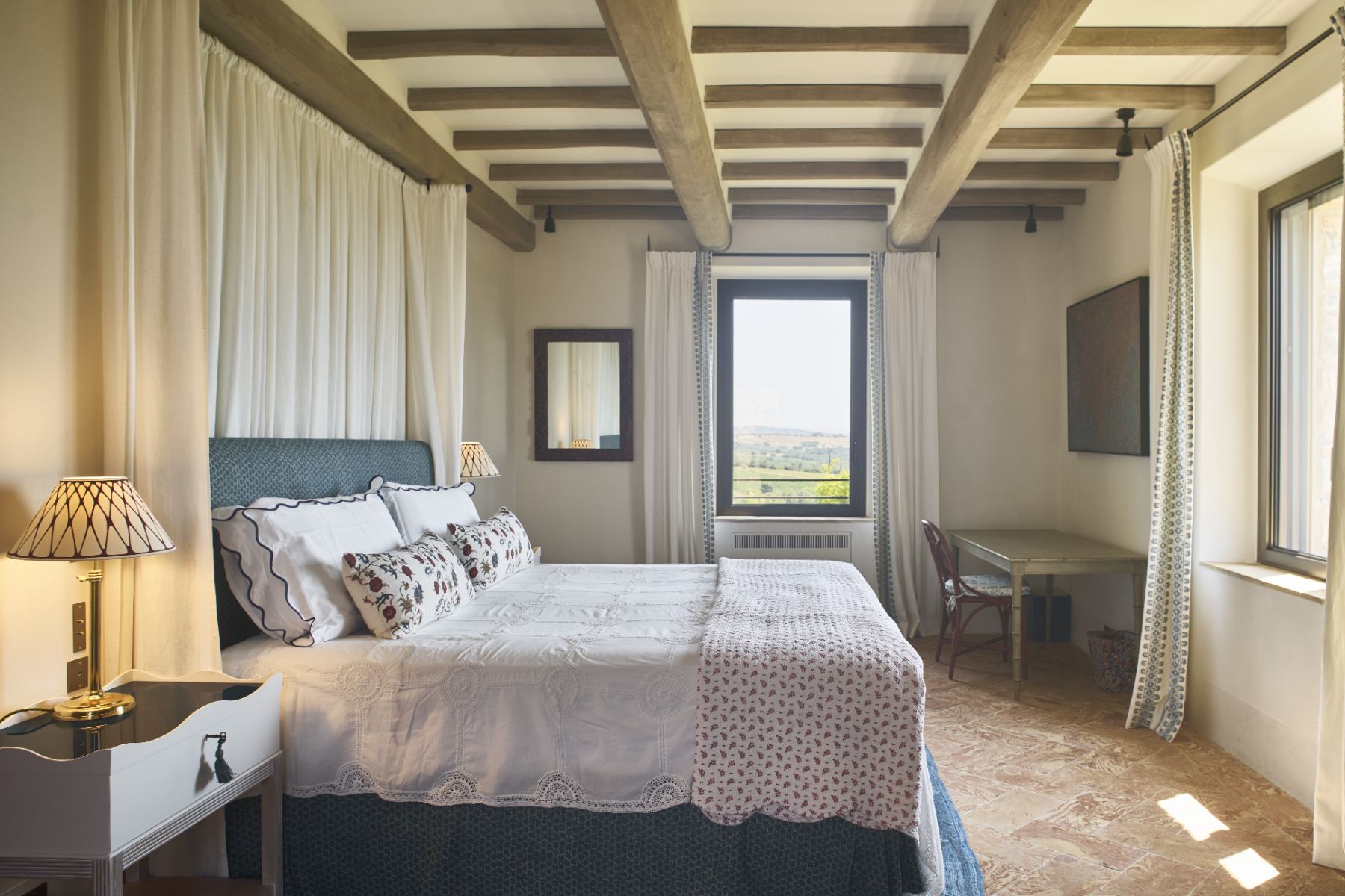 Bedroom with hill views at Villa Roccamare in Tuscany