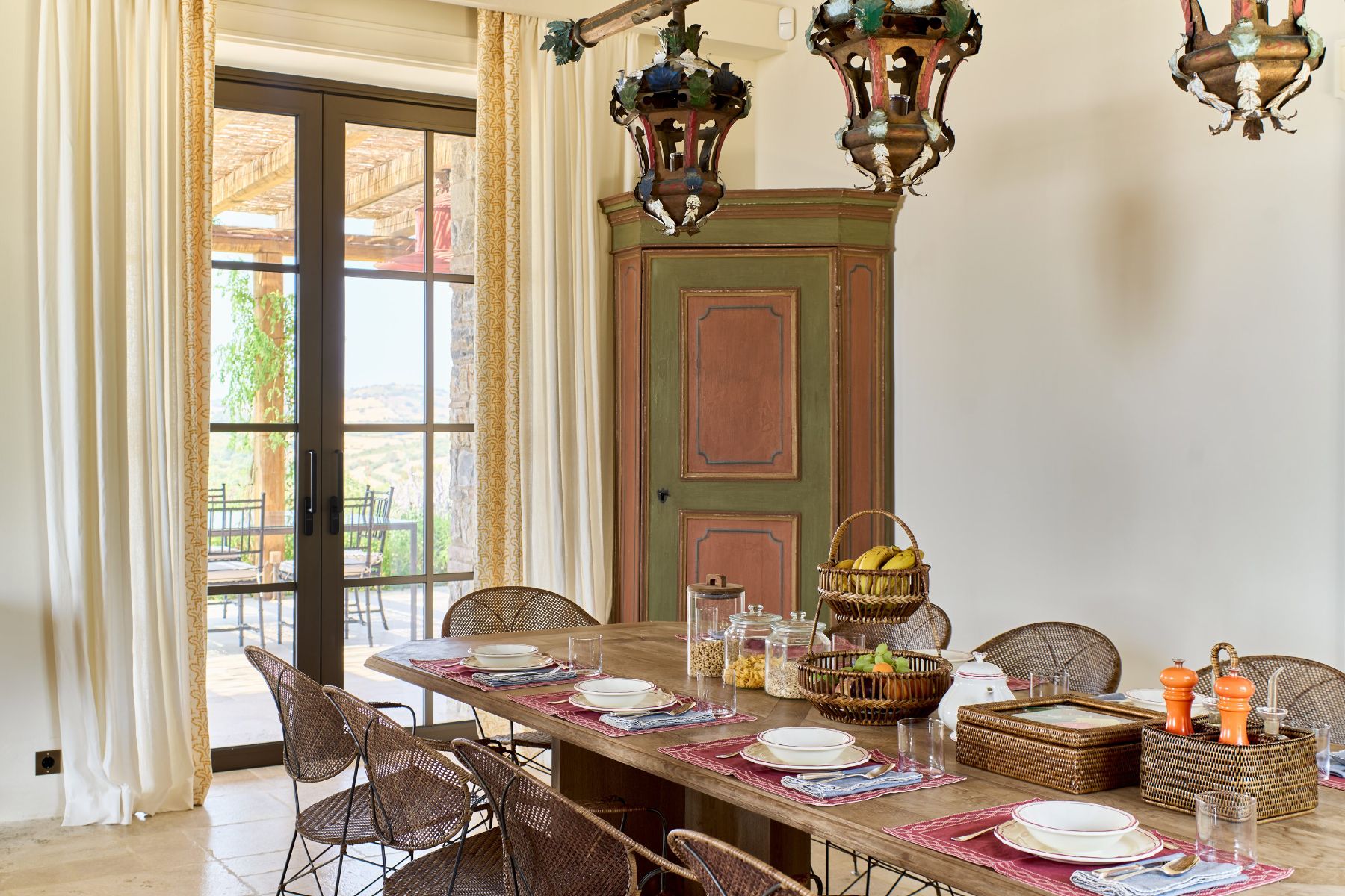 Dining table with plates and fruit at Villa Roccamare in Tuscany