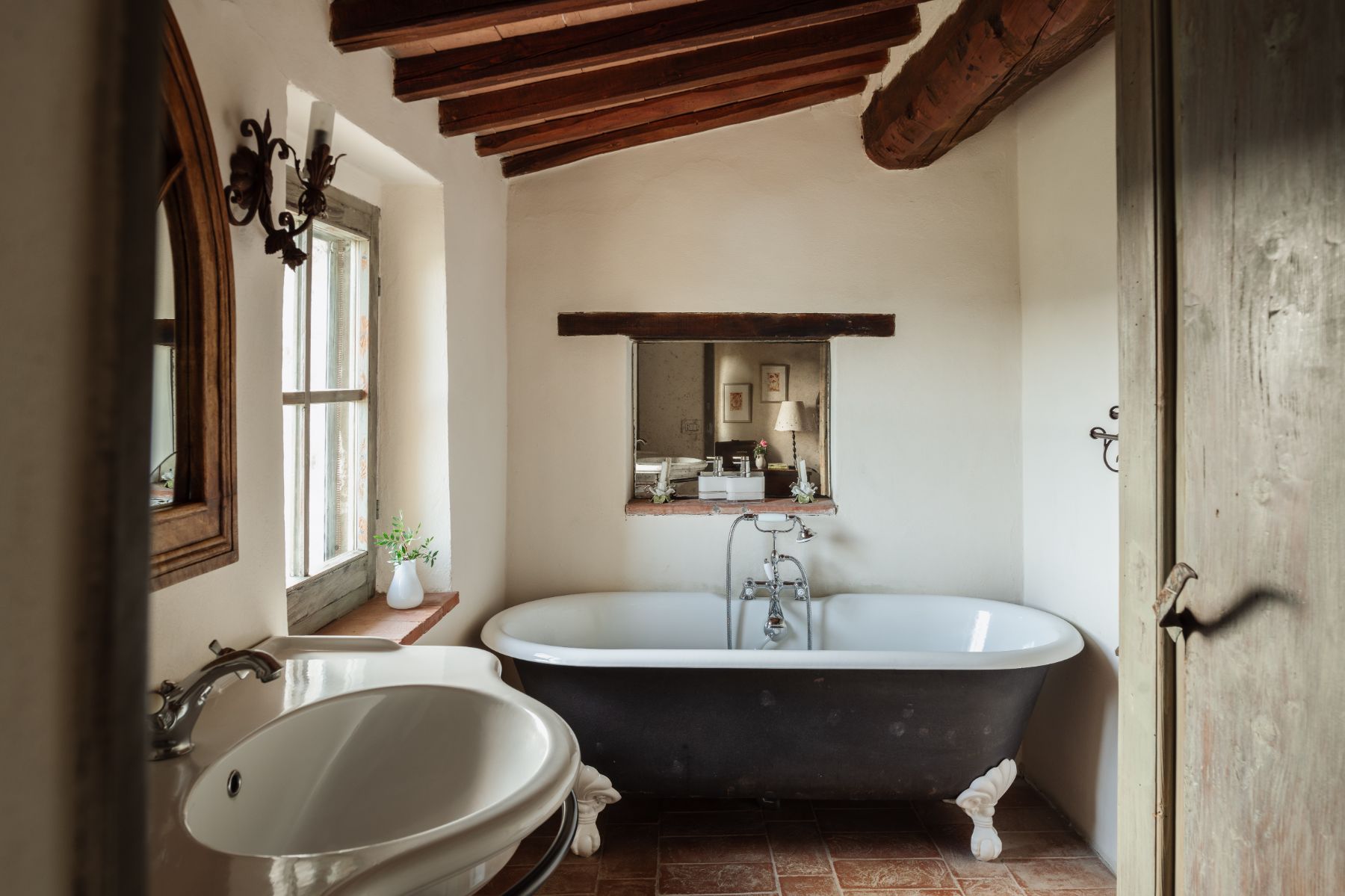 Bathroom with bath tub and a wash basin at Villa San Barberino in Tuscany