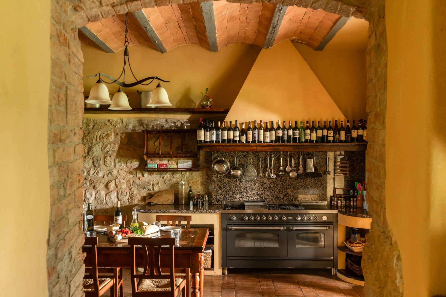 Kitchen with view of the oven and kitchen utensils at Villa San Barberino in Tuscany