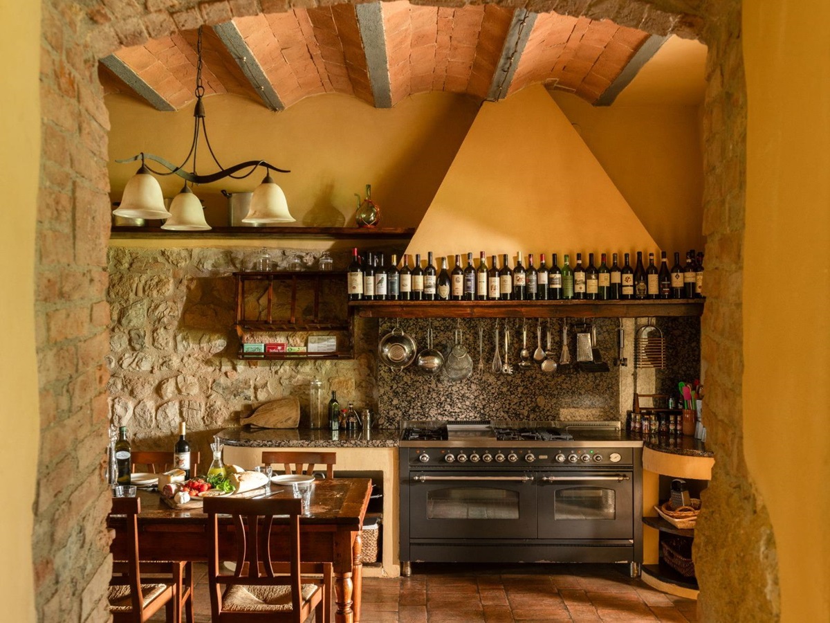 Kitchen with view of the oven and kitchen utensils at Villa San Barberino in Tuscany