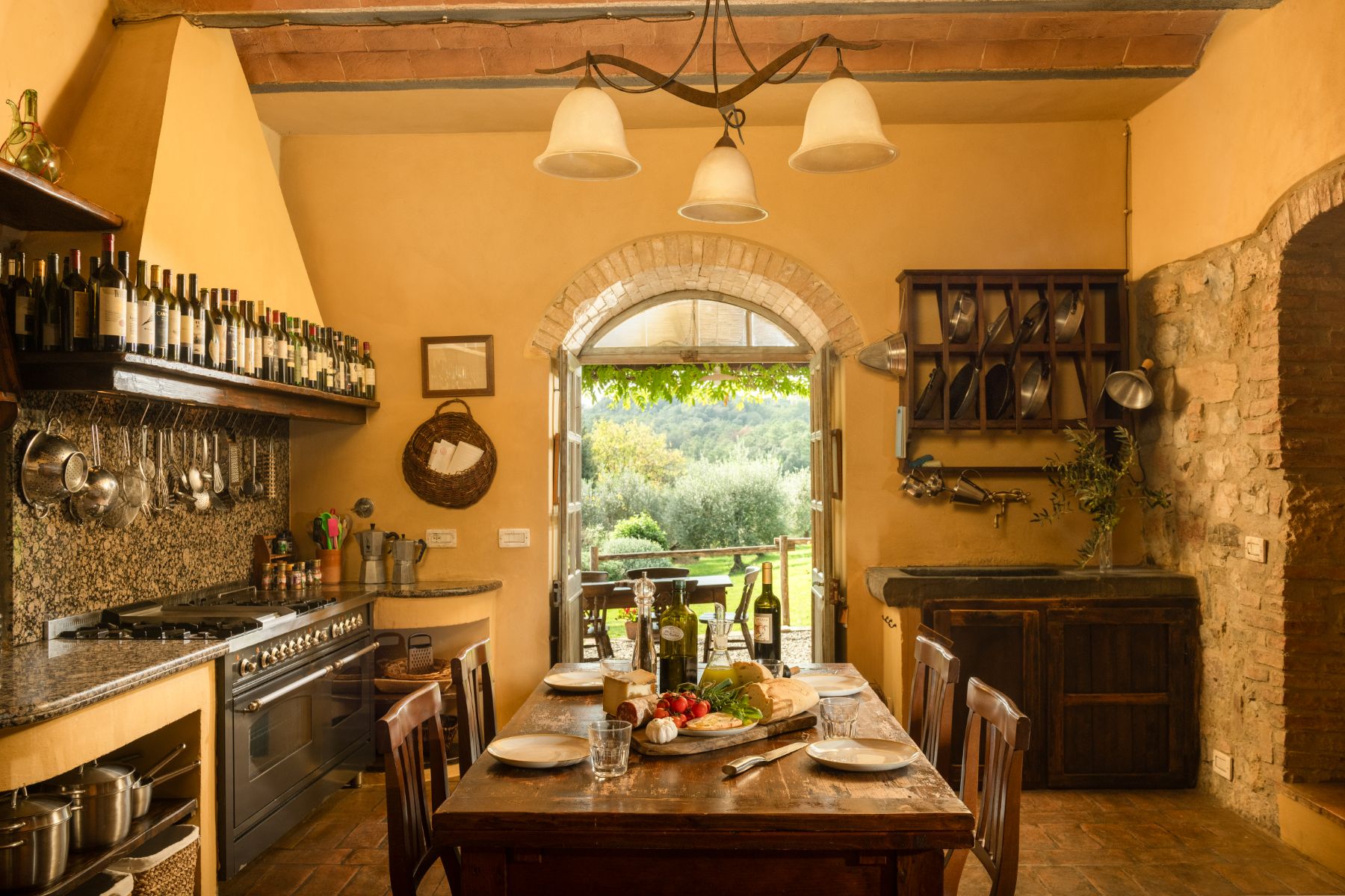 Wooden kitchen table with fresh food on the table at Villa San Barberino in Tuscany
