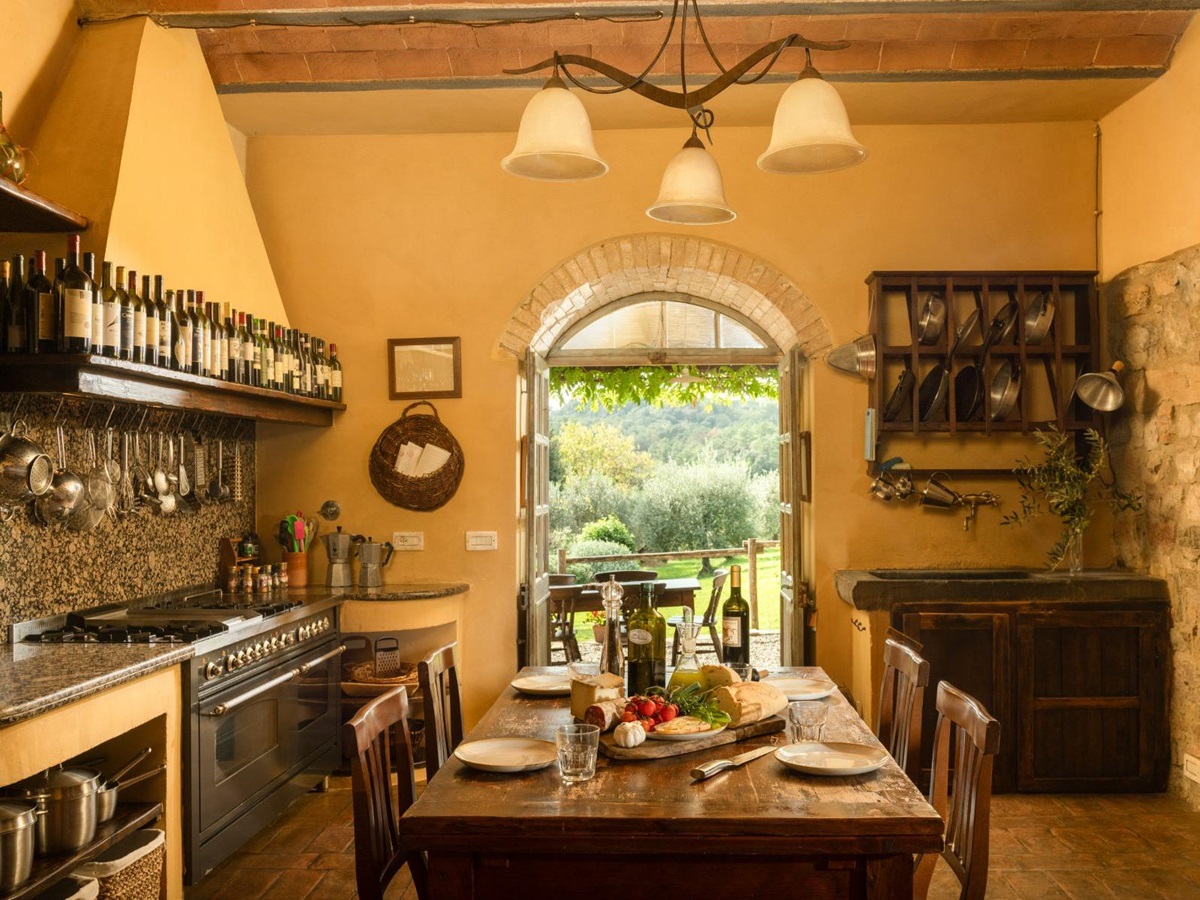 Wooden kitchen table with fresh food on the table at Villa San Barberino in Tuscany