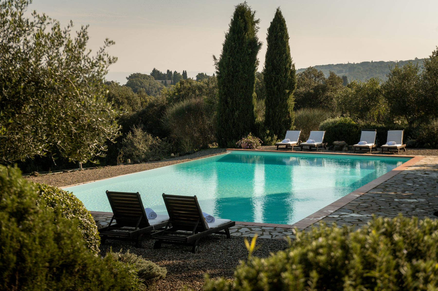 Outdoor pool with with four sun loungers at San Barberino in Tuscany