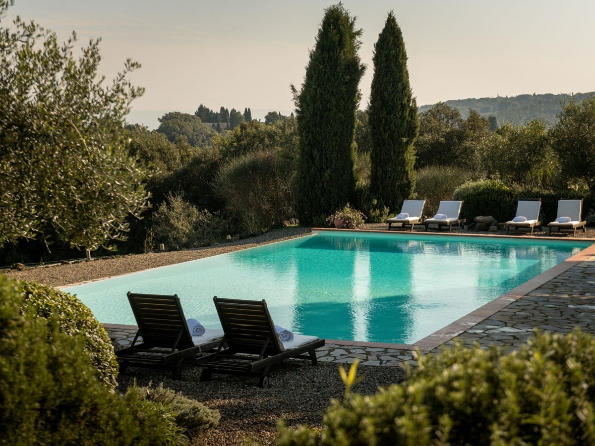 Outdoor pool with with four sun loungers at San Barberino in Tuscany