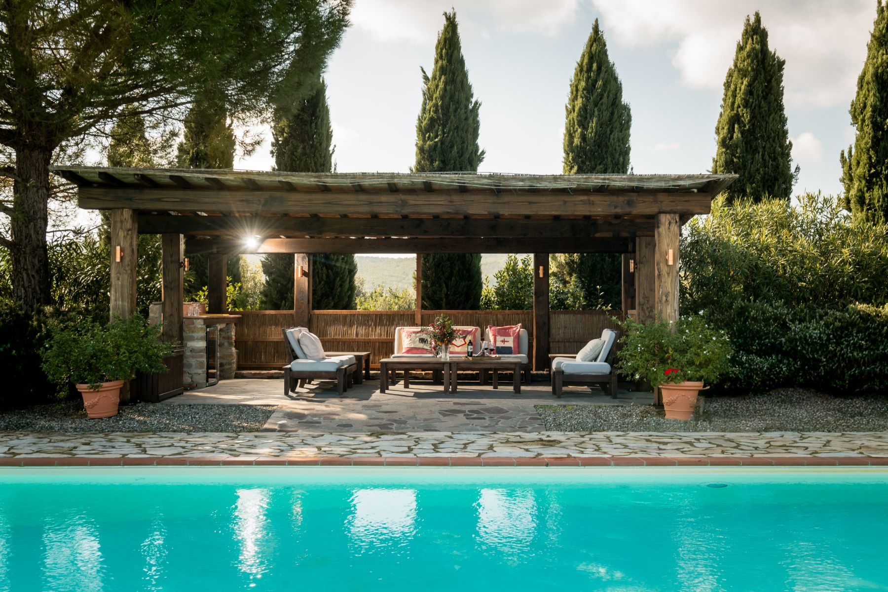Outdoor pool area overlooking the lounge seating at Villa San Barberino in Tuscany