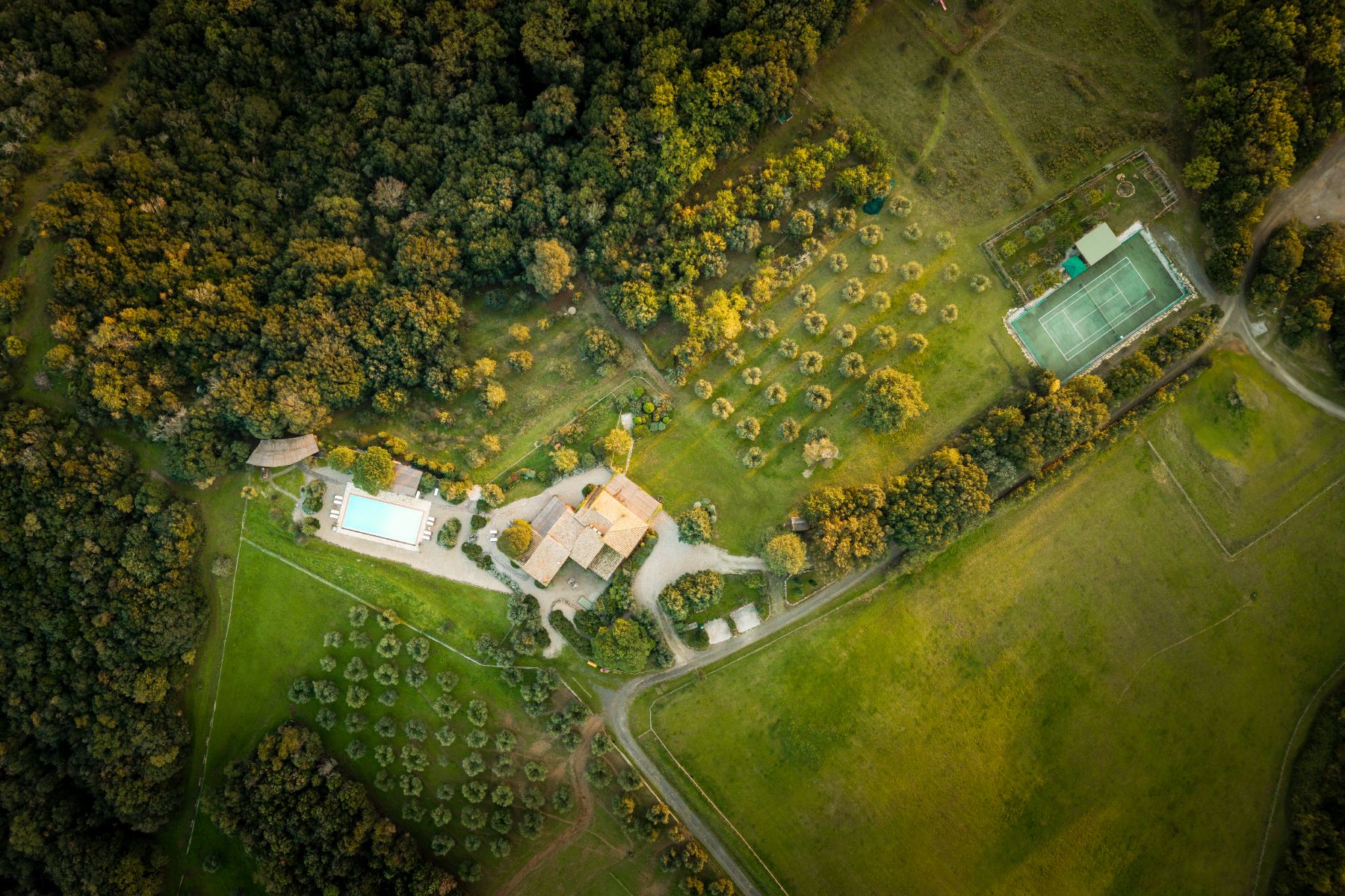 Overhead drone view of Villa San Barberino and the tennis court in Tuscany