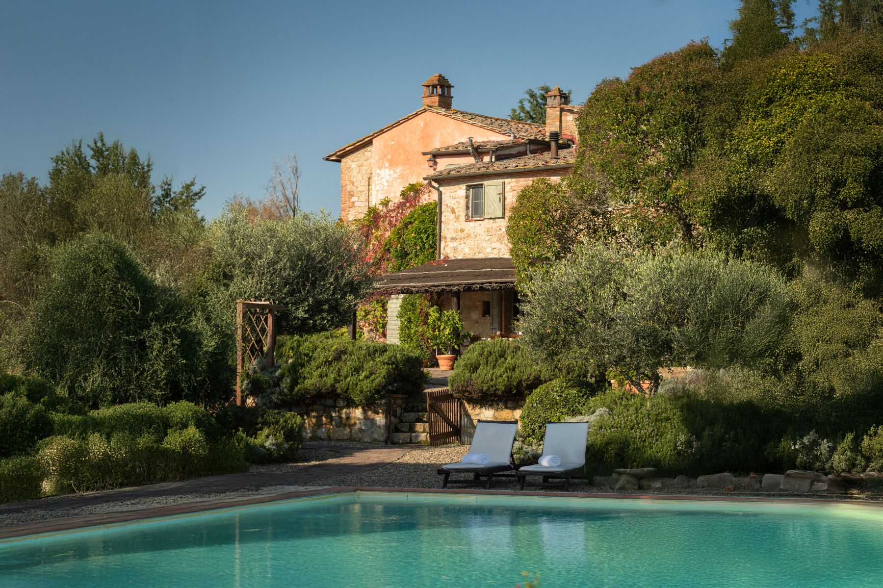 Pool area with view of the front of Villa San Barberino in Tuscany