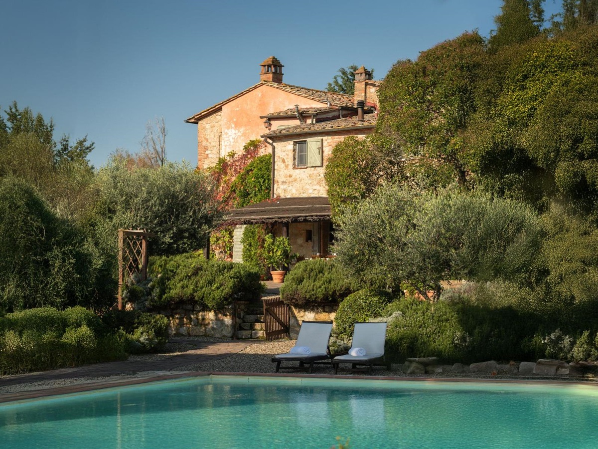 Pool area with view of the front of Villa San Barberino in Tuscany