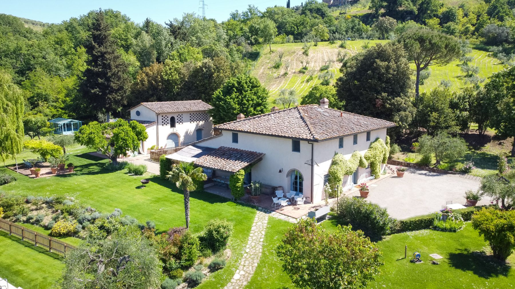 View of villa San Casciano surrounded by gardens and hills in Tuscany