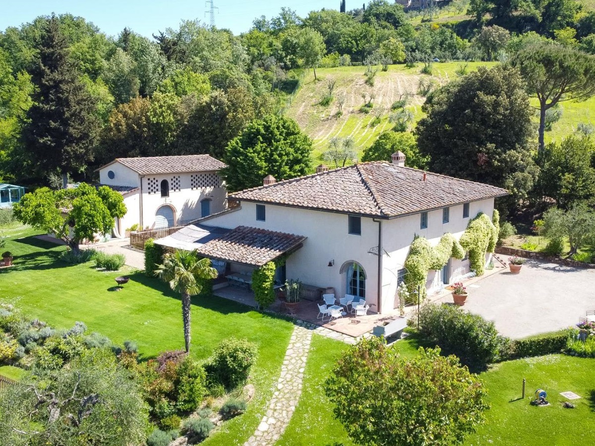 View of villa San Casciano surrounded by gardens and hills in Tuscany