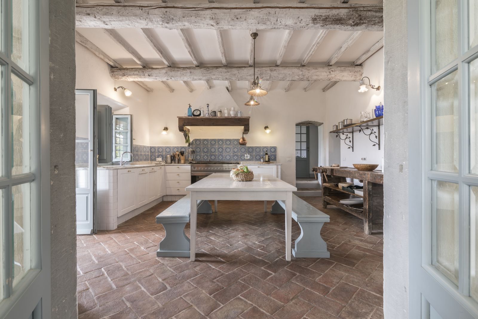 Kitchen with table and seating benches at Villa San Casciano in  Tuscany