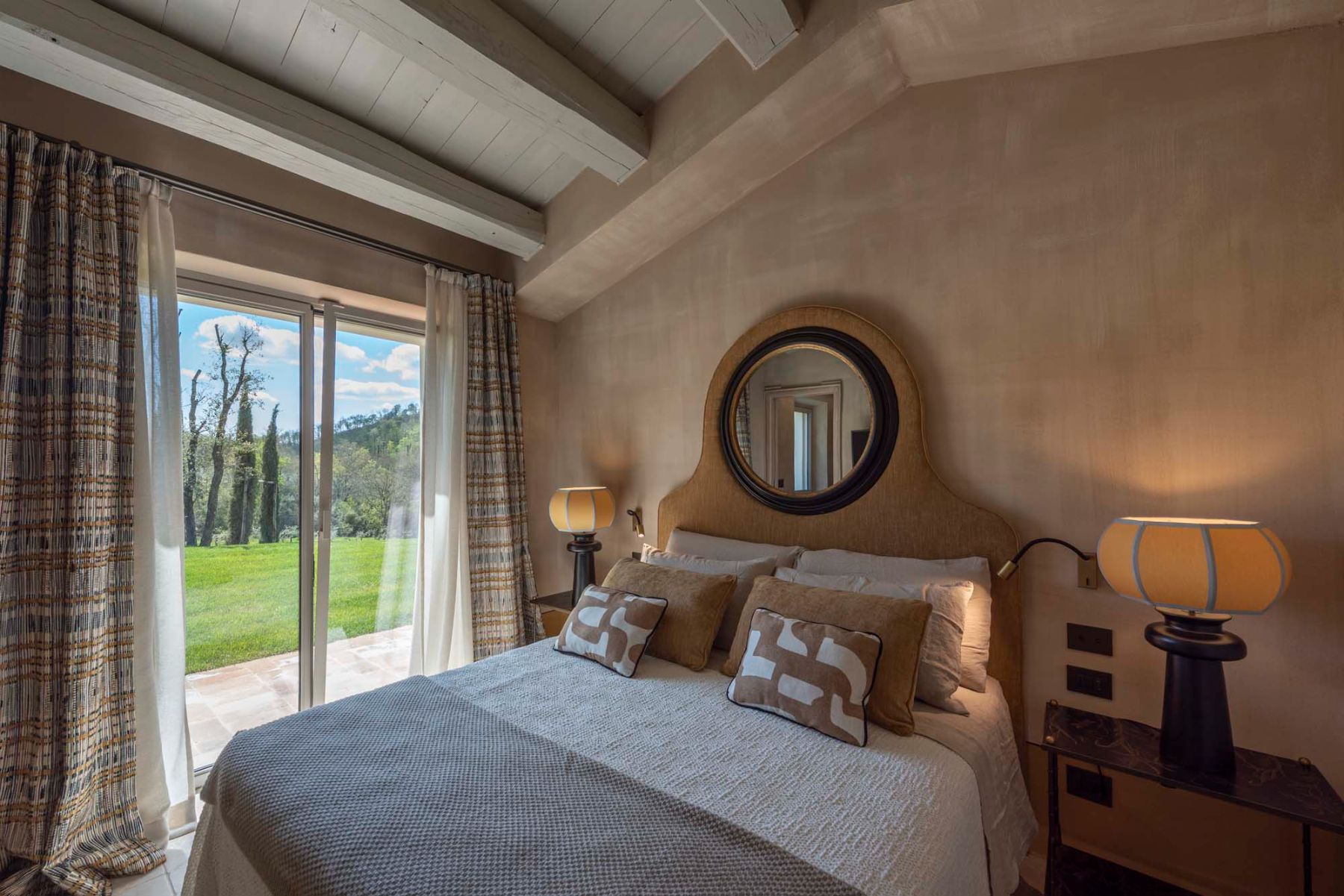 Double bedroom with wall mirror at Villa Tenerezza in Tuscany