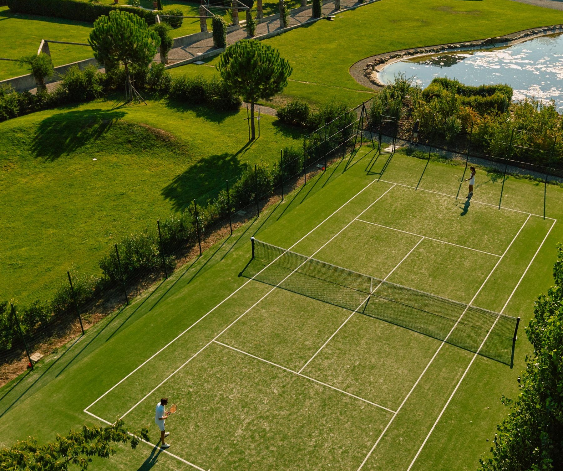 Tennis court and lake at Villa Vorno in Tuscany