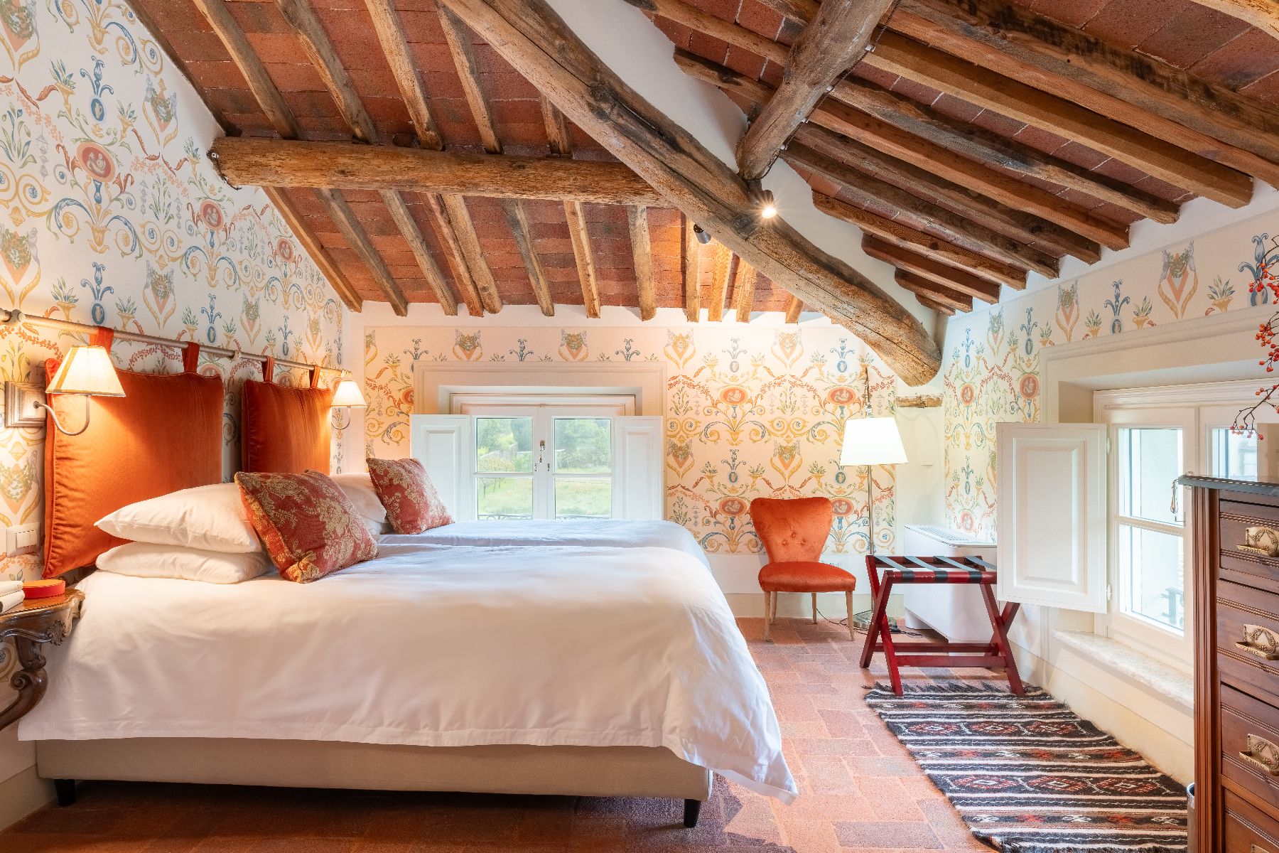 Wooden beam bedroom at Villa Vorno in Tuscany