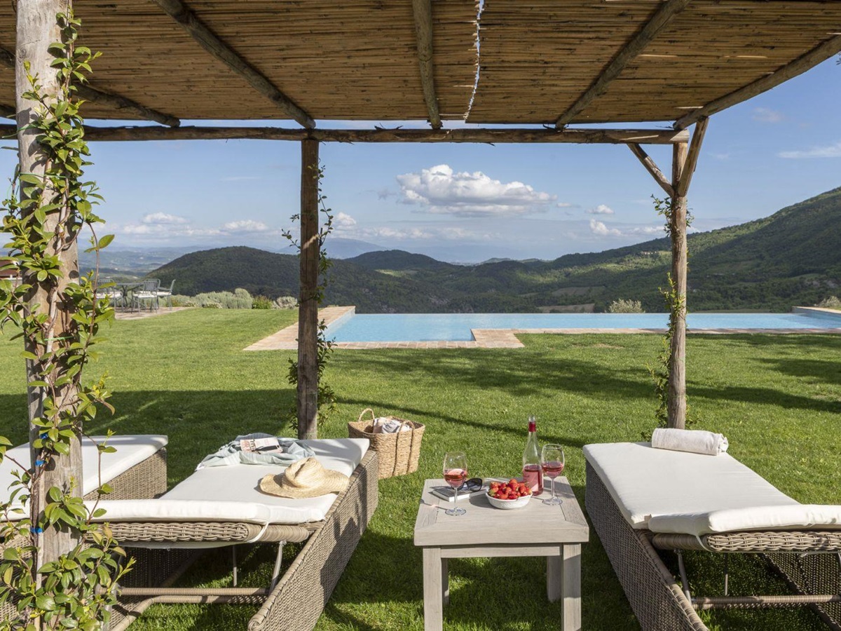 View of the pool from sun loungers at Bel Canto, Umbria