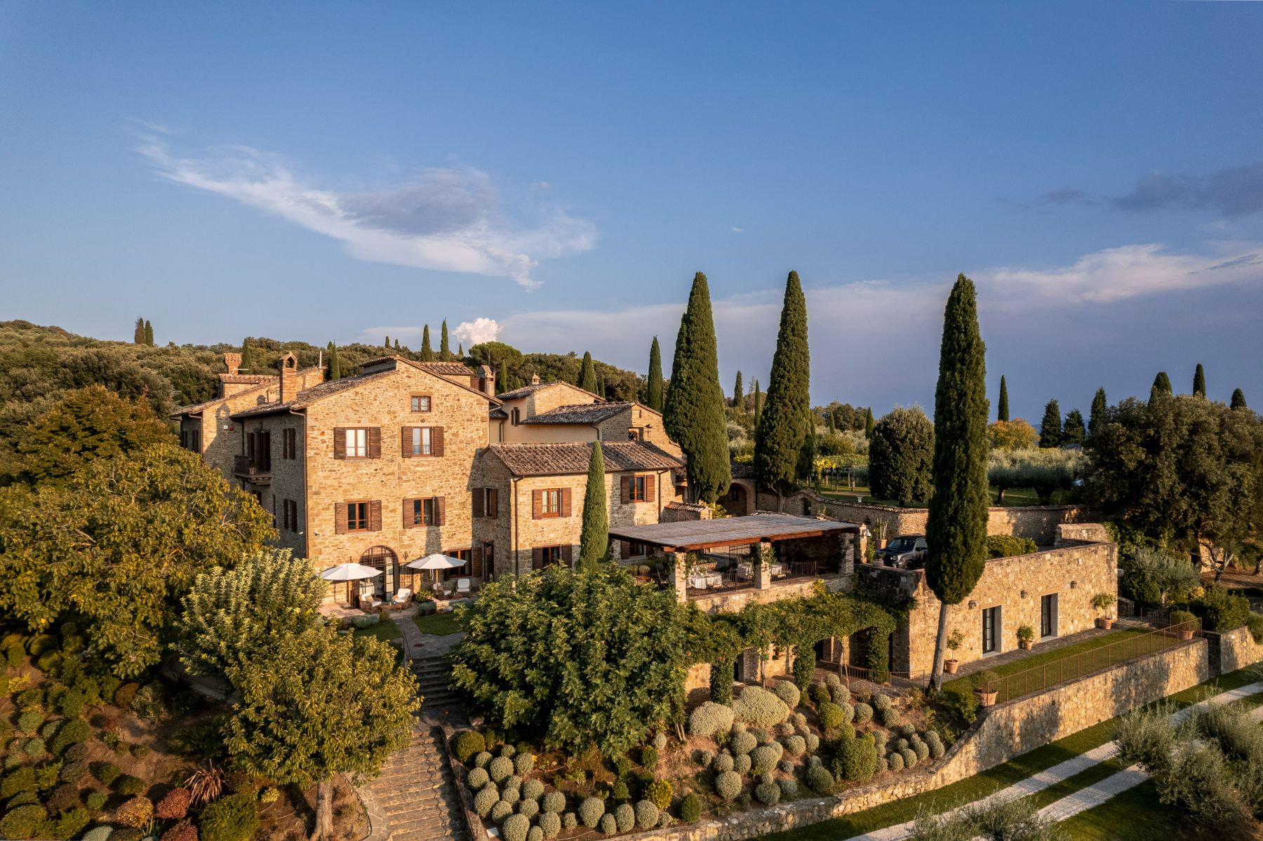Drone view of Villa Il Conventoin Umbria surrounded by trees 