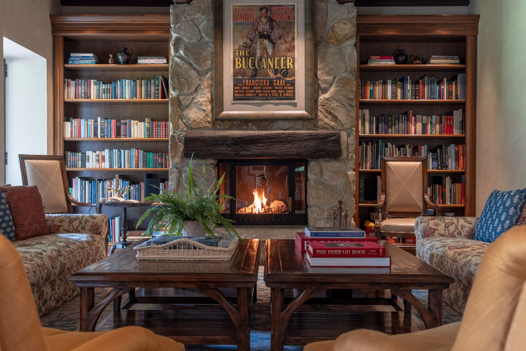 Library with fireplace and armchairs at Villa Il Convento in Umbria