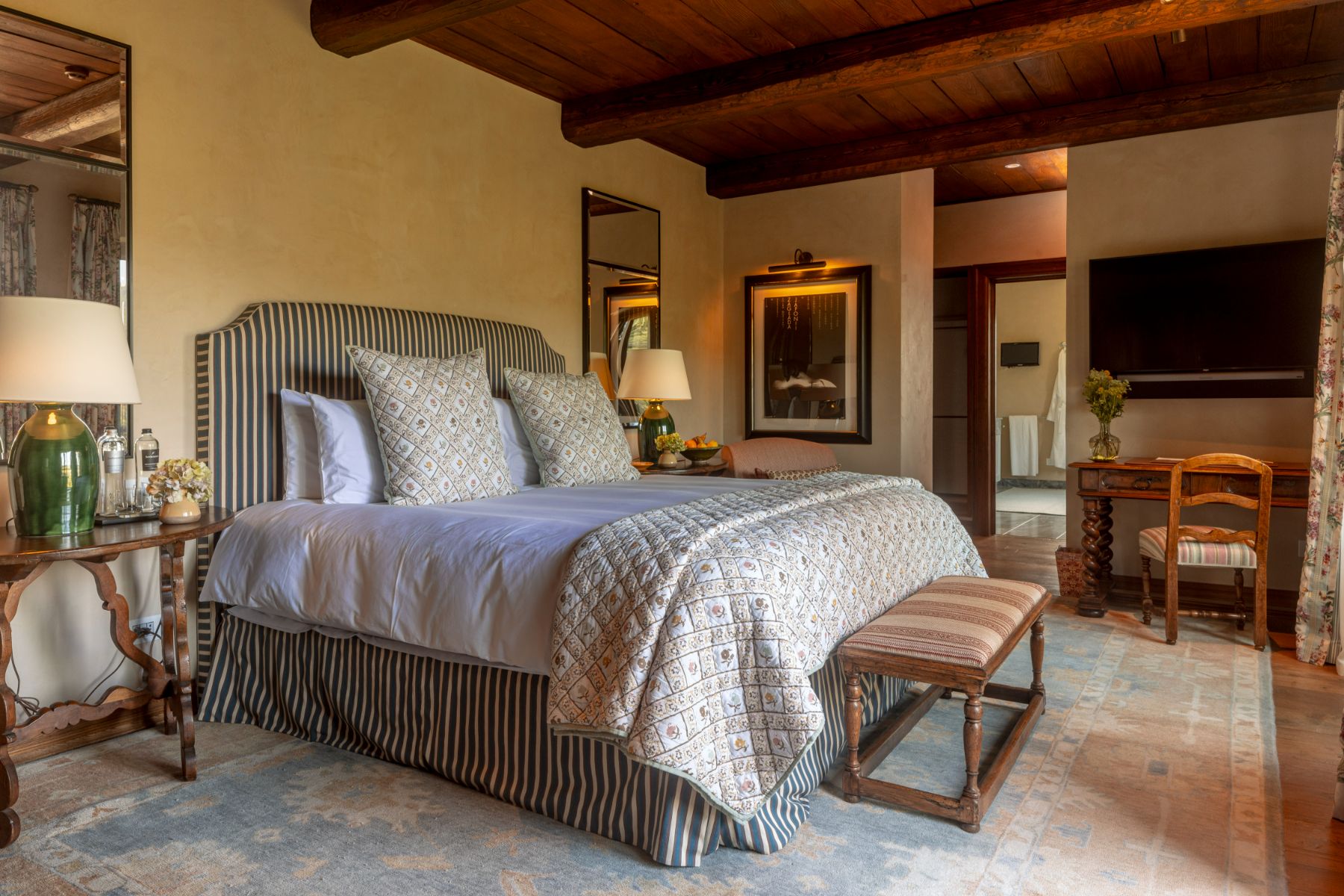 Double bedroom at Villa Il Convento in Umbria with a bed site table and wooden desk with chair