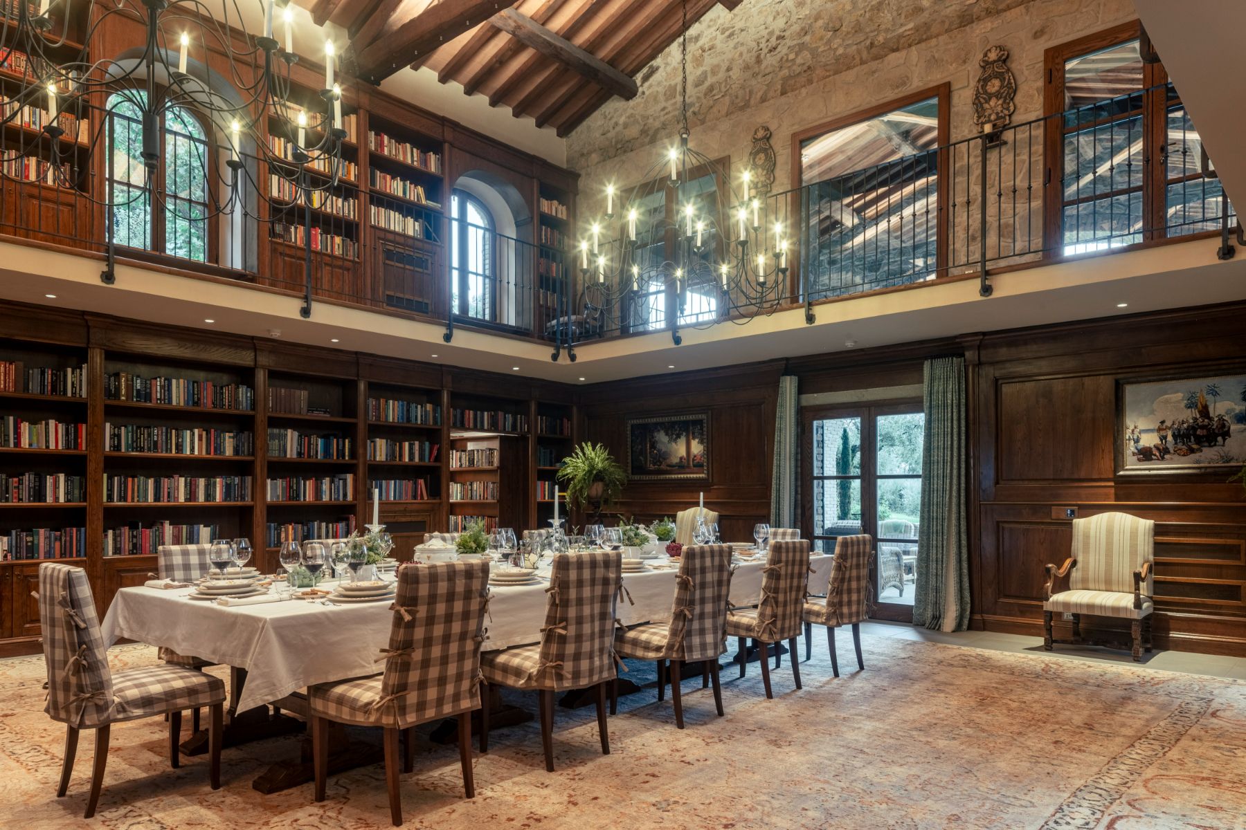 Indoor dining room with bookshelves on the walls at Villa Il Convento in Umbria