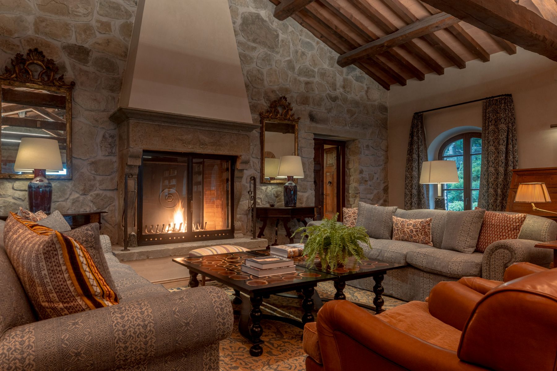 Indoor living area with sofas and a fireplace at Villa Il Convento in Umbria
