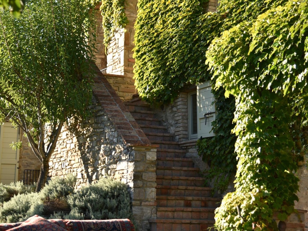 An exterior shot of Villa il Falco, including an external staircase.