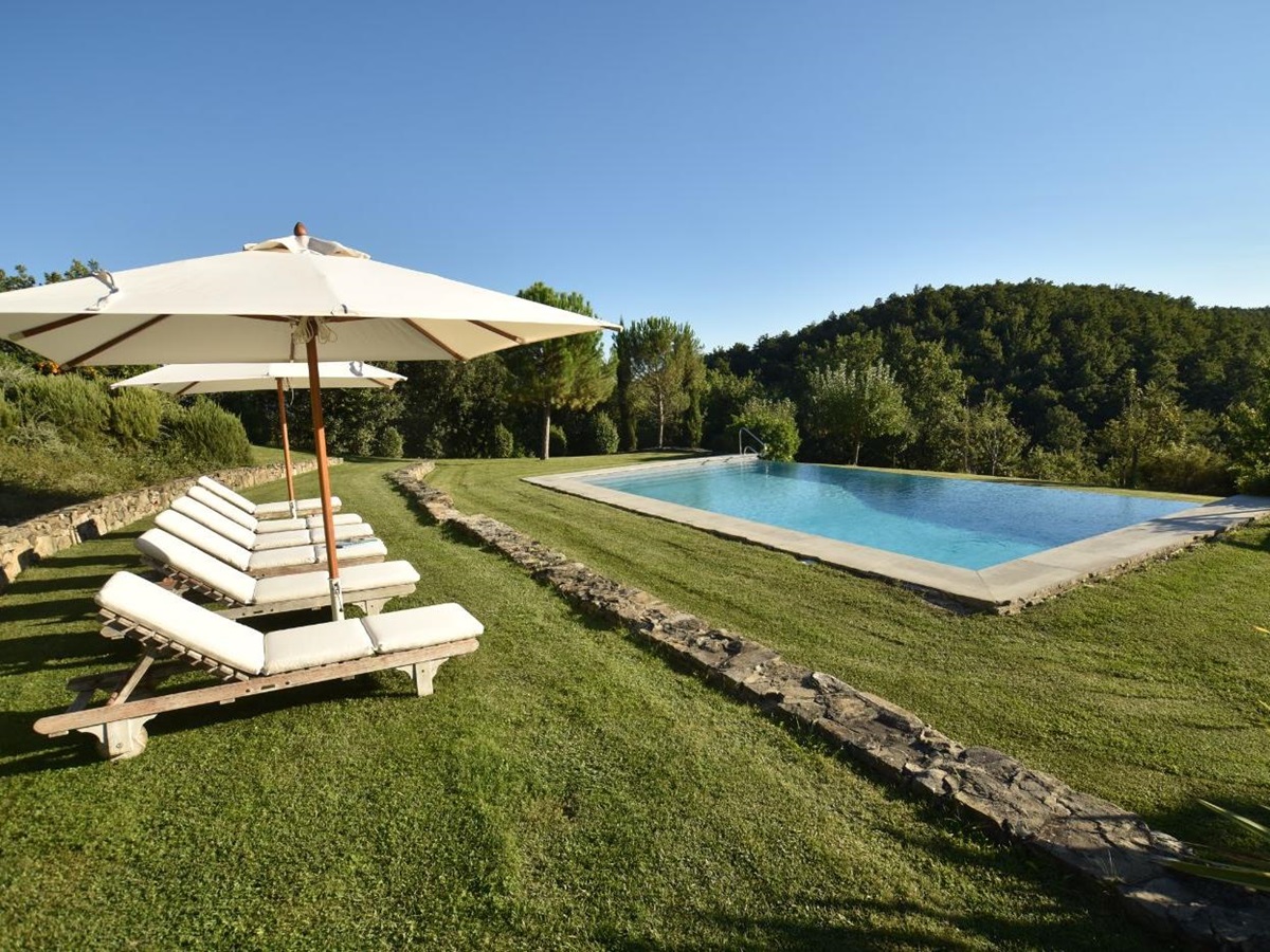 The pool and loungers at Villa il Falco.