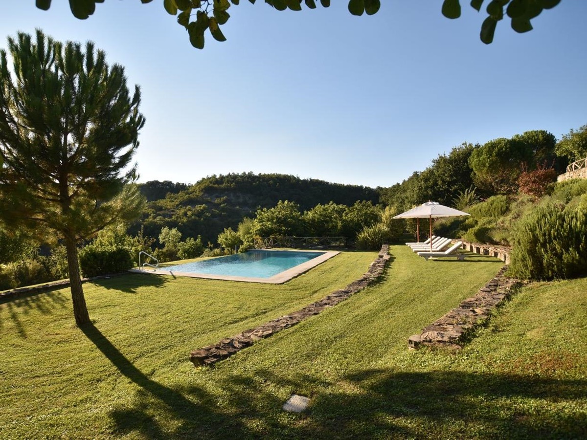 The pool and surrounding greenery at Villa il Falco.