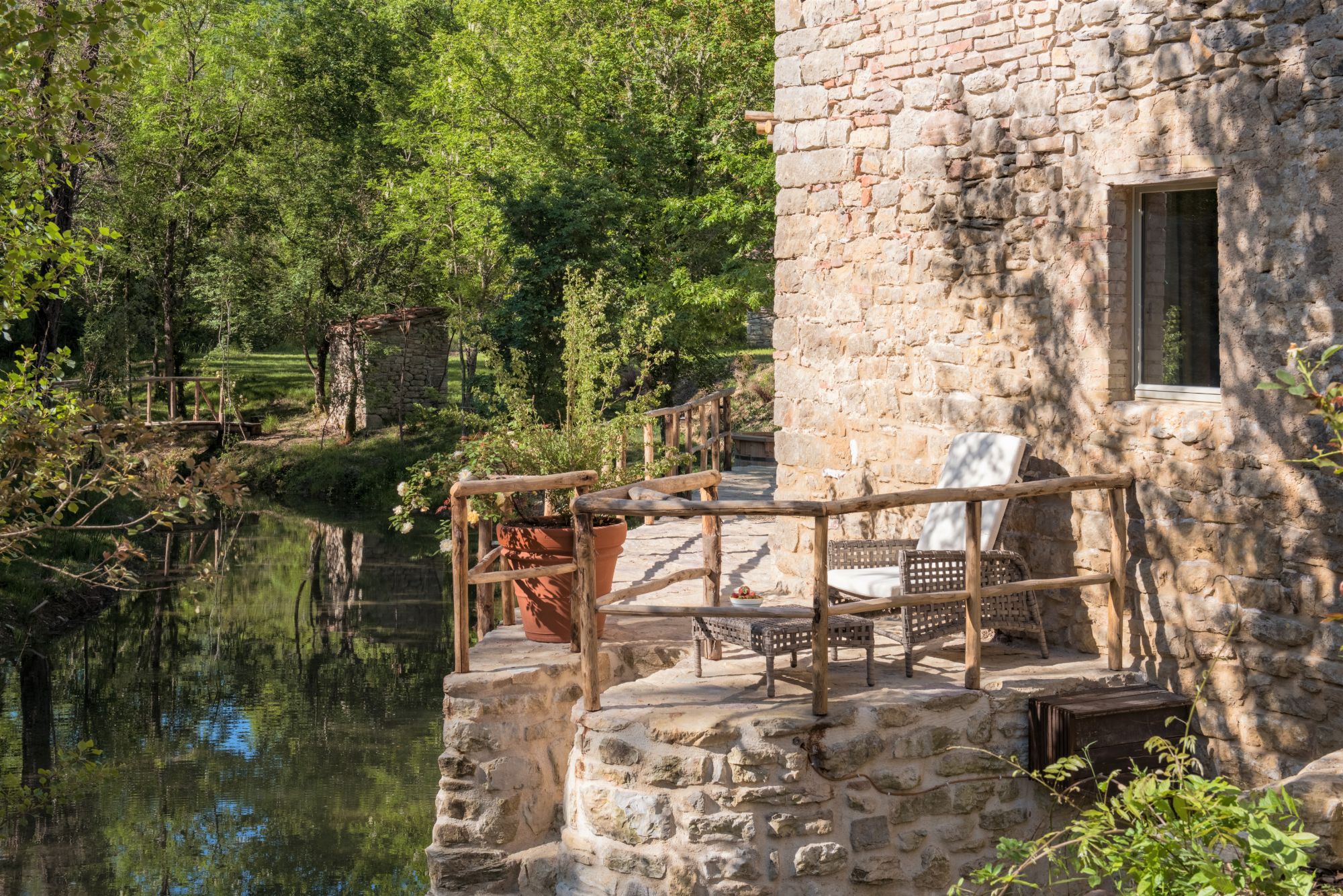 Outdoor seating with river view at Il Molino