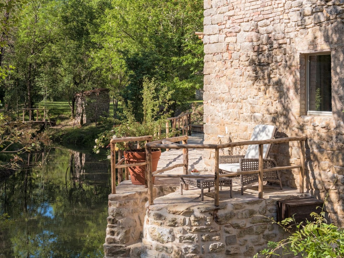 Outdoor seating with river view at Il Molino