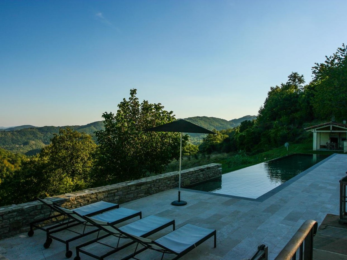 The views of rolling hills beyond the infinity pool at La Spighetta.