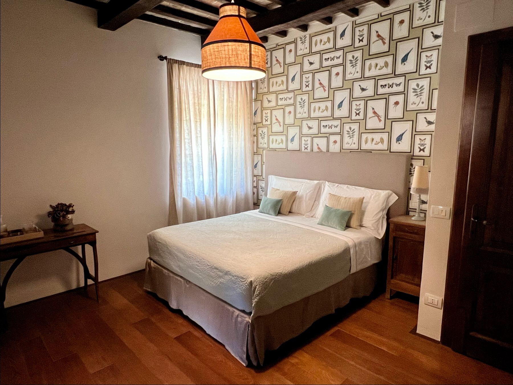 Double bedroom with bird wall art at L'Eremo in Umbria