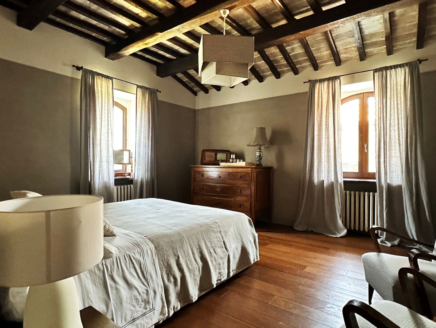 Double bedroom with wooden beams at L'Eremo in Umbria
