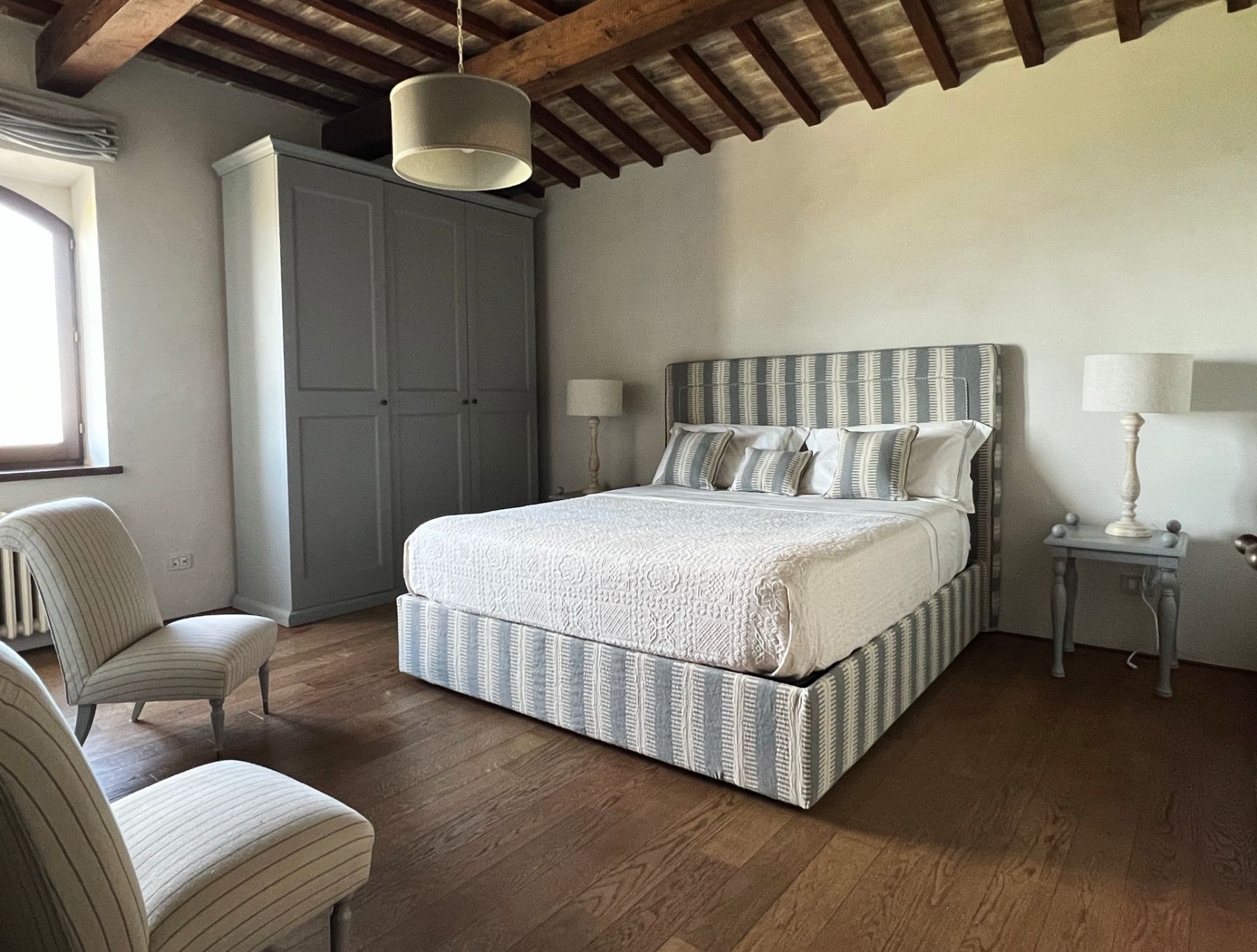 Grey and white stripe double bedroom at L'Eremo in Umbria