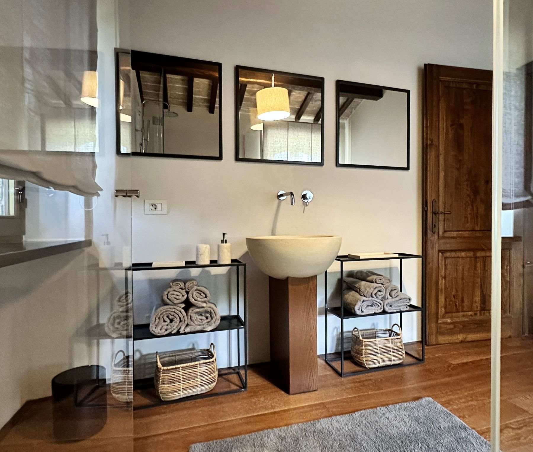 Bathroom with three mirrors at L'Eremo in Umbria