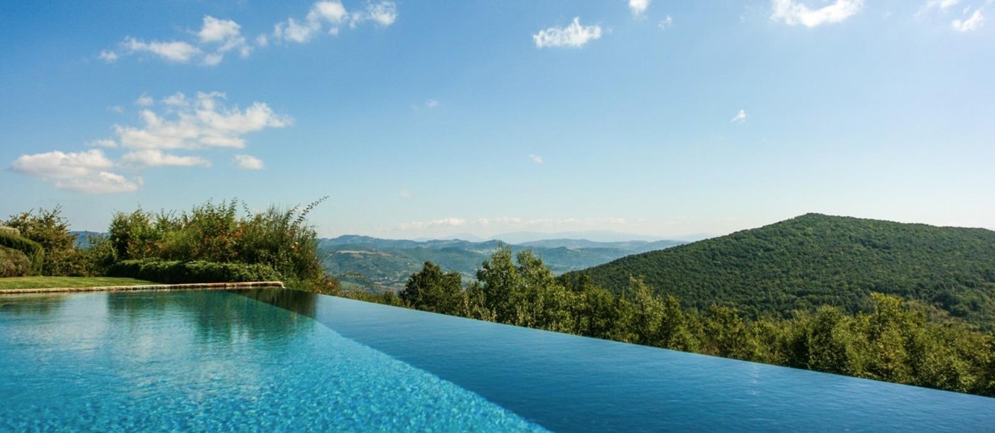 Infinity pool with countryside view at Monticello in Umbria, Italy