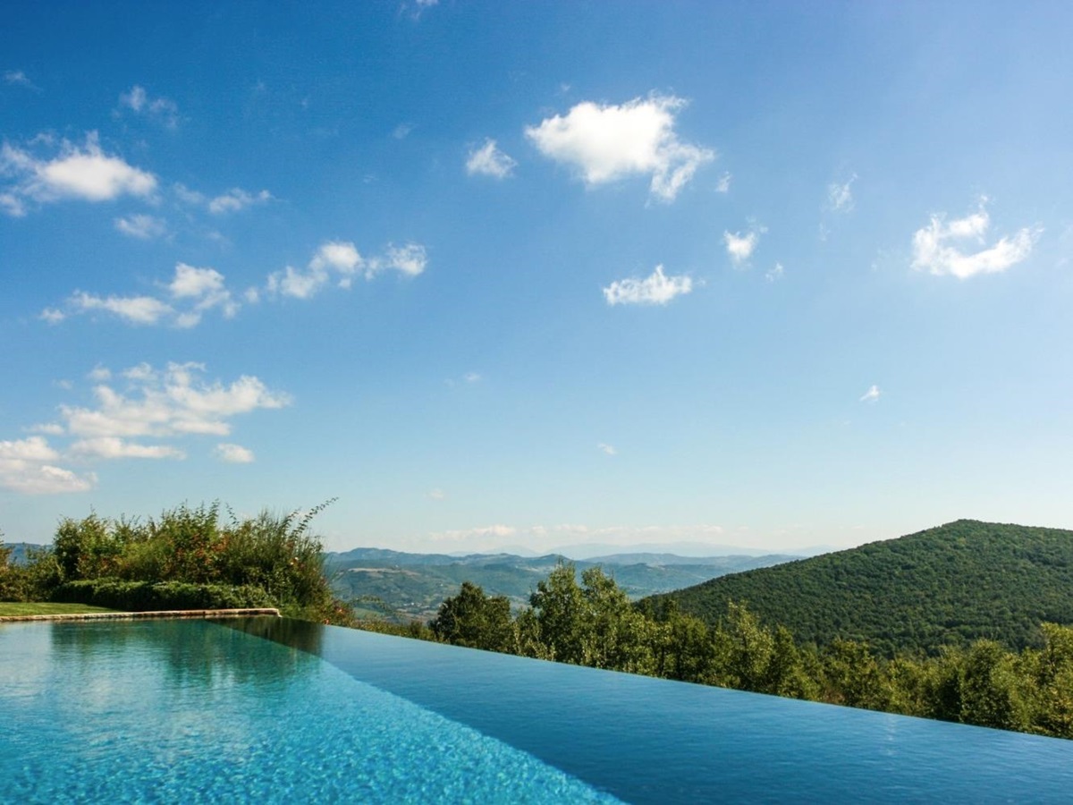 Infinity pool with countryside view at Monticello in Umbria, Italy