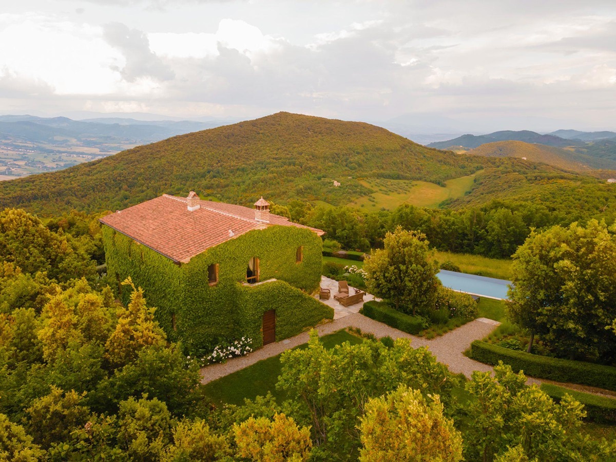 Outdoor drone view of Villa Monticello at the back of the property with view of the pool and rolling hills