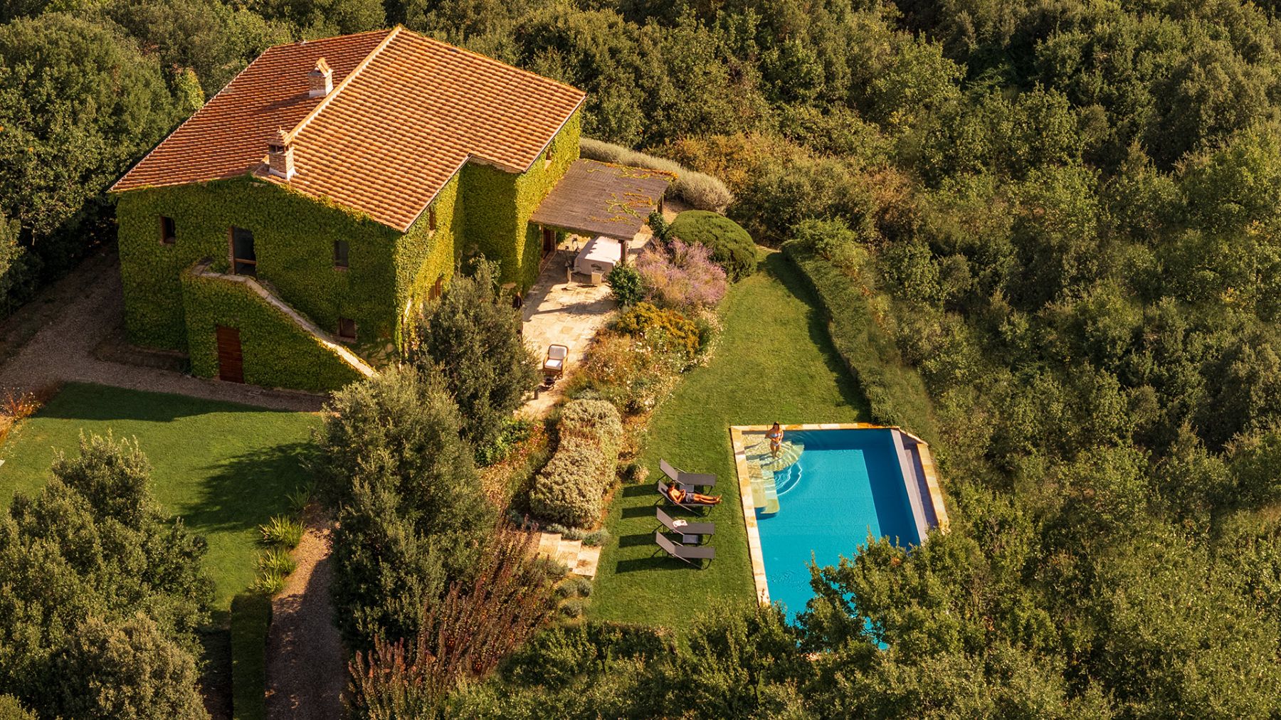 View of the side of Villa Monticello surrounded by trees as well as the outdoor pool