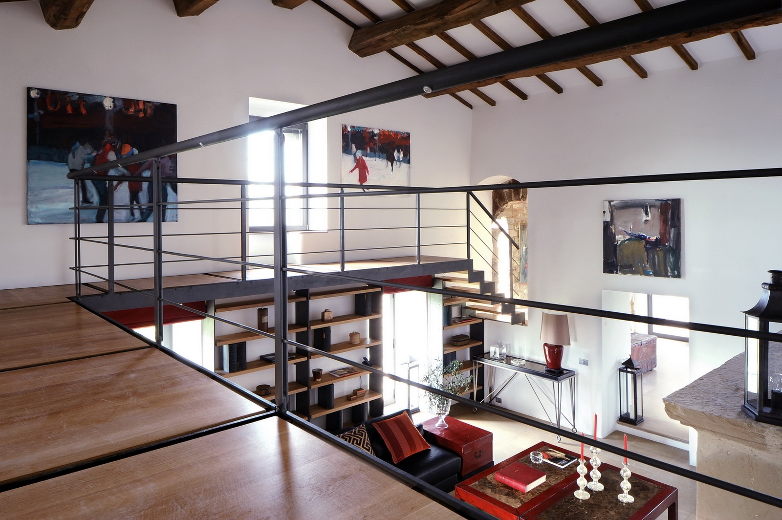 Wooden mezzanine level above the main living room at Villa Arrighi in Umbria