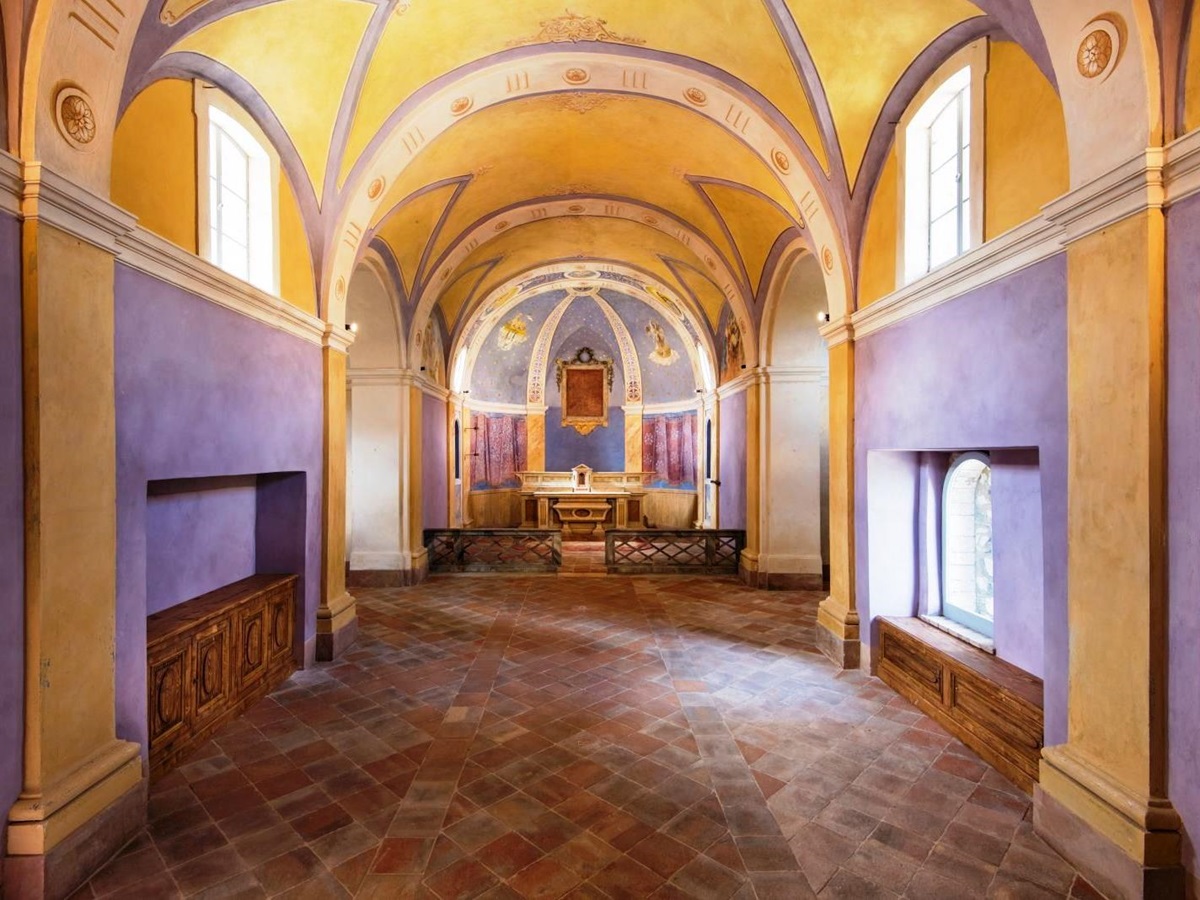 Chapel at villa del conte in umbria, Italy with purple walls and yellow domed ceiling and alter at far end